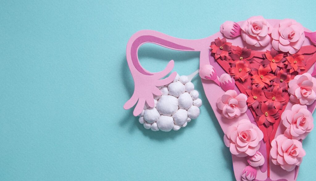 Polycystic ovary syndrome concept art. Uterus made with paper and flowers.