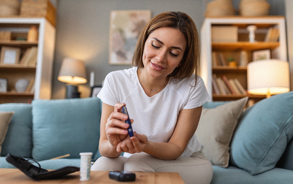 A young woman with diabetes doing an at-home blood sugar test with a glucometer.&nbsp;