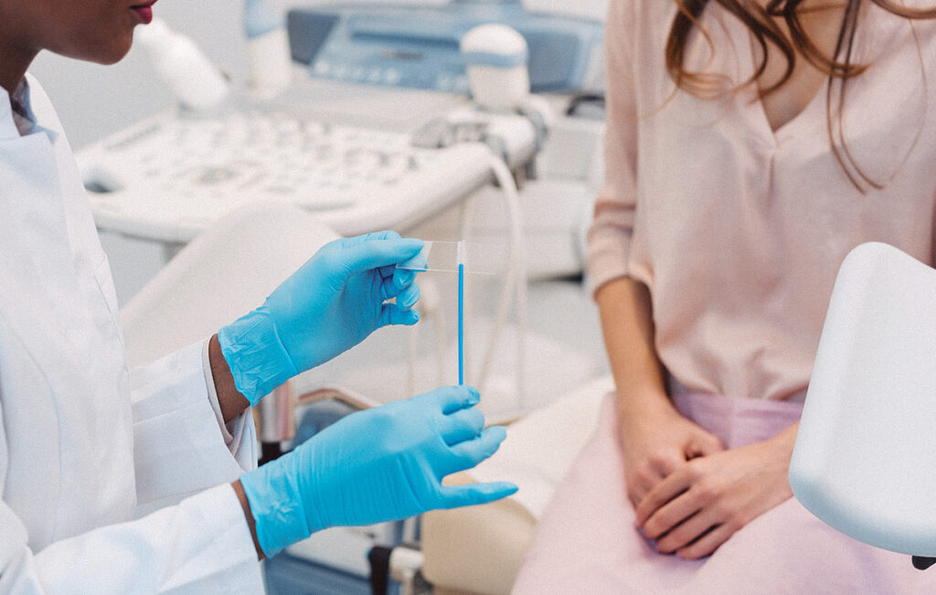 Woman sitting in a doctor's office with a gynecologist to have an STI test.